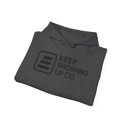 Folded gray hoodie with 'Keep Showing Up Co.' text and logo on a white background